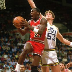 Mark Eaton va après le bloc contre le jeune Michael Jordan lors d'un match de la saison 1984-85.